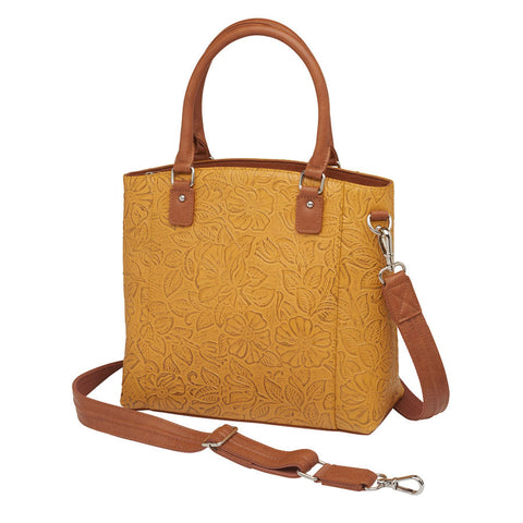 Mustard yellow concealed carry town tote in hand-tooled American cowhide, featuring dual zip-access gun compartment, slash-resistant shoulder straps, and spacious main section with RFID protection