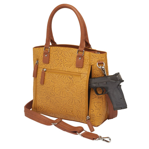 Mustard yellow concealed carry town tote in hand-tooled American cowhide, featuring dual zip-access gun compartment, slash-resistant shoulder straps, and spacious main section with RFID protection