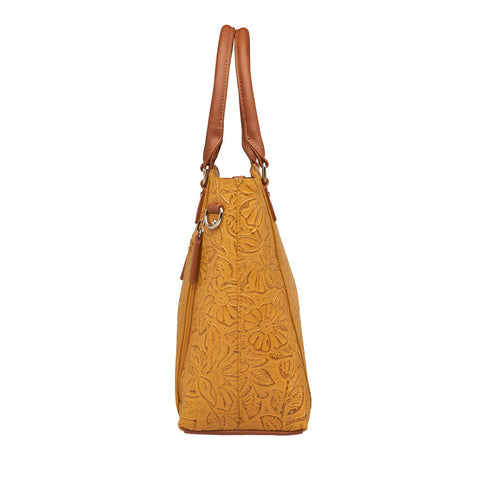 Mustard yellow concealed carry town tote in hand-tooled American cowhide, featuring dual zip-access gun compartment, slash-resistant shoulder straps, and spacious main section with RFID protection