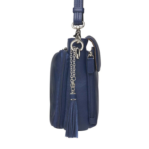 Indigo blue clutch-style concealed carry purse in soft American cowhide with RFID-protected front organizer, adjustable crossbody slash-resistant strap, triple-zip gun access for Glock 27, Ruger LCP, S&W Shield, and more. Lightweight, padded, stylish, and discreet everyday carry solution for women.