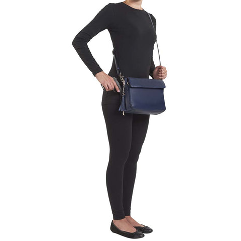 Indigo blue clutch-style concealed carry purse in soft American cowhide with RFID-protected front organizer, adjustable crossbody slash-resistant strap, triple-zip gun access for Glock 27, Ruger LCP, S&W Shield, and more. Lightweight, padded, stylish, and discreet everyday carry solution for women.