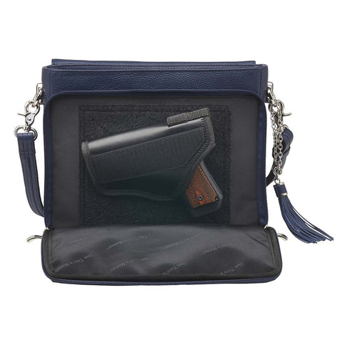 Indigo blue clutch-style concealed carry purse in soft American cowhide with RFID-protected front organizer, adjustable crossbody slash-resistant strap, triple-zip gun access for Glock 27, Ruger LCP, S&W Shield, and more. Lightweight, padded, stylish, and discreet everyday carry solution for women.