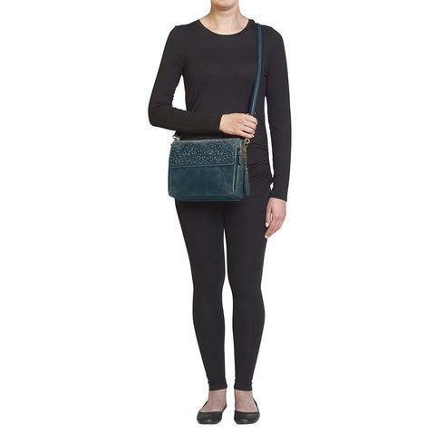 Step up your carry game with this vintage-inspired clutch in rich distressed blue full-grain buffalo leather. The more you rock it, the softer and more unique it becomes thanks to the natural aging process and oils infused during tanning. Designed for both left and right-hand carry, it features special padding to prevent imprinting, plus a slash-resistant shoulder strap reinforced with 11-ply steel wire for maximum security.
