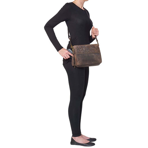 Timeless and tough — this brown distressed full-grain buffalo leather clutch gets better with age and wear. Designed to fit both left and right-handed carriers, it offers special padding to prevent imprinting and a slash-resistant shoulder strap reinforced with 11-ply steel wire for solid security.