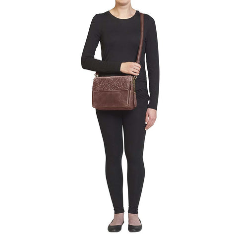 Timeless and tough — this brown distressed full-grain buffalo leather clutch gets better with age and wear. Designed to fit both left and right-handed carriers, it offers special padding to prevent imprinting and a slash-resistant shoulder strap reinforced with 11-ply steel wire for solid security.