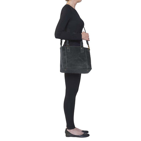 Sophisticated gray distressed full grain buffalo leather concealed carry town tote. Features vintage patina finish that ages gracefully, lightweight yet durable. Equipped with slash-resistant shoulder strap and padded interior for imprint protection. Designed for both left and right handed users, with ample storage including exterior and interior zip pockets. Comes with Mernickle standard holster, tested for reliable concealed carry performance.
