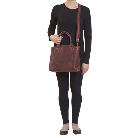 Bold distressed red full grain buffalo leather town tote with concealed carry functionality. Soft yet rugged vintage leather develops unique patina with everyday wear. Slash-resistant adjustable crossbody strap with padded gun compartment protects against imprinting. Designed for ambidextrous draw, multiple organizational pockets including secure zipper compartments. Includes Mernickle holster tested for compact and subcompact pistols. Perfect for confident, stylish concealed carry.