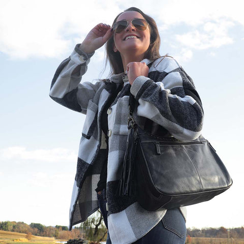 women holding a Slate gray concealed carry HOBO purse in soft vintage leather with dark chrome rivets, RFID protection, dual zip compartments, CCW access for Glock 26 or Sig P320, slash-proof shoulder strap, and left/right hand draw compatibility.