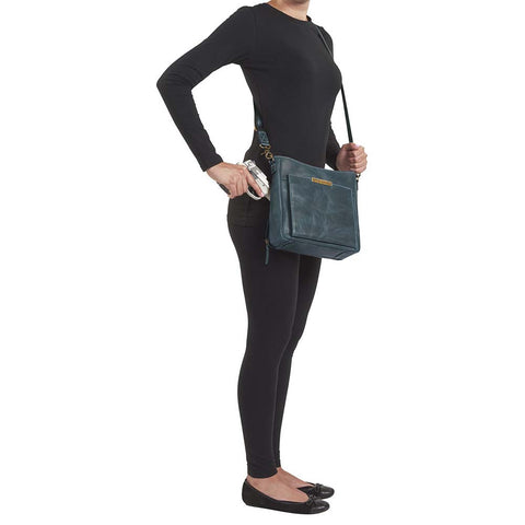 Slim concealed carry purse in distressed vintage blue buffalo leather, includes RFID wallet organizer, top-draw holster access, fits Glock 19, Sig P320, or HK VP9, built-in slash-resistant strap.
