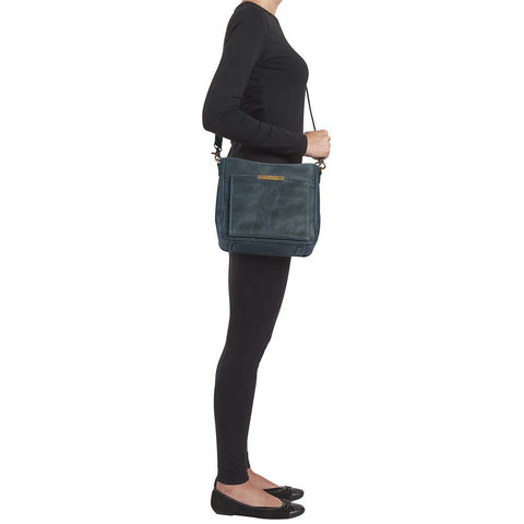 Slim concealed carry purse in distressed vintage blue buffalo leather, includes RFID wallet organizer, top-draw holster access, fits Glock 19, Sig P320, or HK VP9, built-in slash-resistant strap.