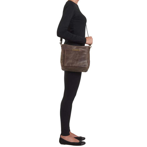 Slim crossbody concealed carry purse in distressed brown full-grain buffalo leather with RFID wallet organizer, top-draw gun compartment, fits Glock 19, Sig Sauer P320, or M&P Shield, slash-resistant strap.