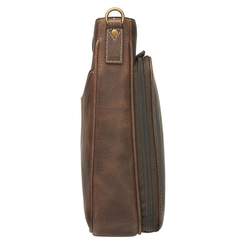 Distressed brown buffalo leather crossbody mail pouch with vintage patina, RFID protection, slash-resistant strap, and concealed carry holster compatible with left or right draw